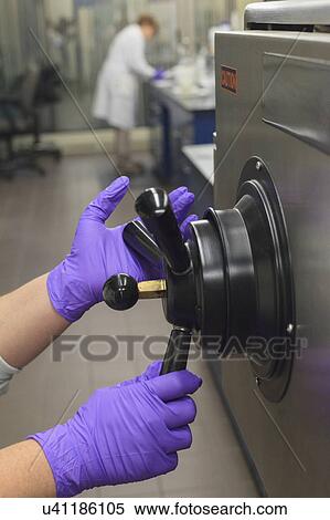 Stock Photography - Lab technician opening sterilization tank.. Fotosearch
