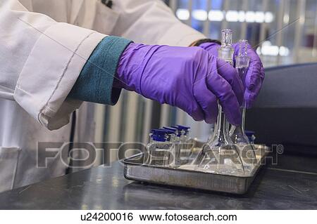 Stock Photograph - Lab technician picking up samples.. Fotosearch