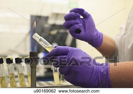 Lab technician removing sample vial cap. View Large Photo Image Stock Image - Lab technician removing sample vial cap.. Fotosearch