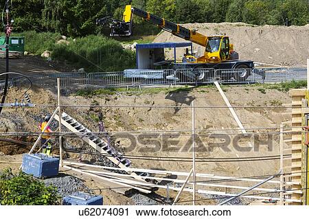 Stock Image - Large mobile crane during construction of a bridge.. Fotosearch