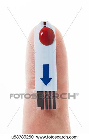 Stock Image - MODEL RELEASED. Blood sample on glucose test strip, studio shot.. Fotosearch