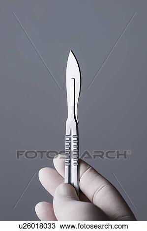 MODEL RELEASED. Person wearing latex glove holding scalpel. View Large Photo Image Stock Image - MODEL RELEASED. Person wearing latex glove holding scalpel.. Fotosearch