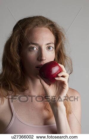 MODEL RELEASED. Portrait of woman eating red apple as part of a healthy diet. View Large Photo Image Stock Image - MODEL RELEASED. Portrait of woman eating red apple as part of a healthy diet.. Fotosearch