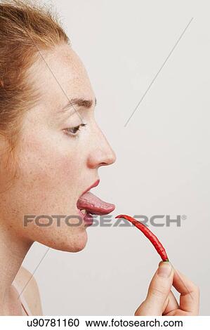 MODEL RELEASED. Profile of woman testing the heat of a red chili with her tongue. View Large Photo Image Stock Image - MODEL RELEASED. Profile of woman testing the heat of a red chili with her tongue.. Fotosearch
