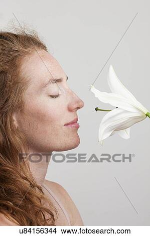 MODEL RELEASED. Profile of young woman with red hair smelling white flower. View Large Photo Image Picture - MODEL RELEASED. Profile of young woman with red hair smelling white flower.. Fotosearch