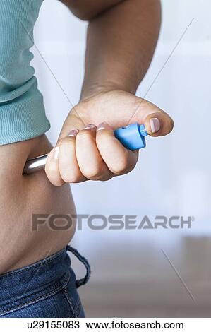 MODEL RELEASED. Woman injecting herself in her side. View Large Photo Image Stock Image - MODEL RELEASED. Woman injecting herself in her side.. Fotosearch
