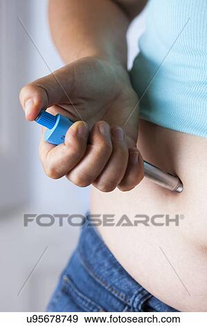 MODEL RELEASED. Woman injecting herself in the abdomen. View Large Photo Image Stock Photo - MODEL RELEASED. Woman injecting herself in the abdomen.. Fotosearch