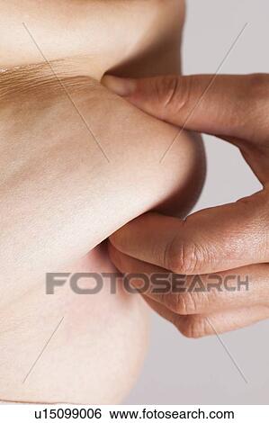 MODEL RELEASED. Woman pinching flesh on her waist, close up. View Large Photo Image Stock Photograph - MODEL RELEASED. Woman pinching flesh on her waist, close up.. Fotosearch
