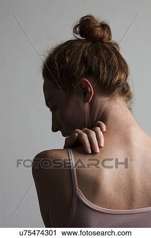 MODEL RELEASED. Woman touching her neck and back. View Large Photo Image Stock Image - MODEL RELEASED. Woman touching her neck and back.. Fotosearch
