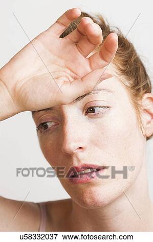 MODEL RELEASED. Woman touching her forehead with hand. View Large Photo Image Stock Photo - MODEL RELEASED. Woman touching her forehead with hand.. Fotosearch