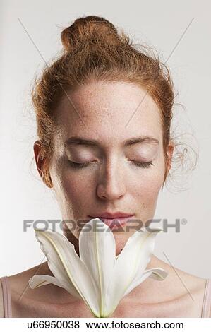 MODEL RELEASED. Woman with e1 closed smelling white flower. View Large Photo Image Stock Photo - MODEL RELEASED. Woman with e1 closed smelling white flower.. Fotosearch