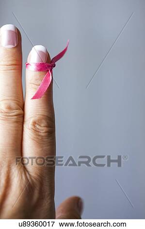 MODEL RELEASED. Woman with pink ribbon tied to finger. View Large Photo Image Stock Photo - MODEL RELEASED. Woman with pink ribbon tied to finger.. Fotosearch