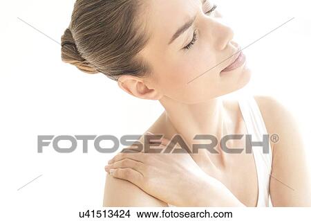 MODEL RELEASED. Young woman in pain rubbing her shoulder. View Large Photo Image Picture - MODEL RELEASED. Young woman in pain rubbing her shoulder.. Fotosearch