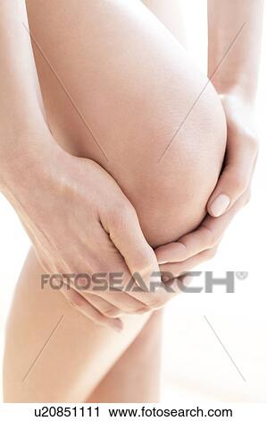 MODEL RELEASED. Young woman in pain rubbing her sore knee, close up. View Large Photo Image Stock Image - MODEL RELEASED. Young woman in pain rubbing her sore knee, close up.. Fotosearch