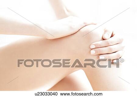MODEL RELEASED. Young woman in pain rubbing her sore knee. View Large Photo Image Stock Image - MODEL RELEASED. Young woman in pain rubbing her sore knee.. Fotosearch