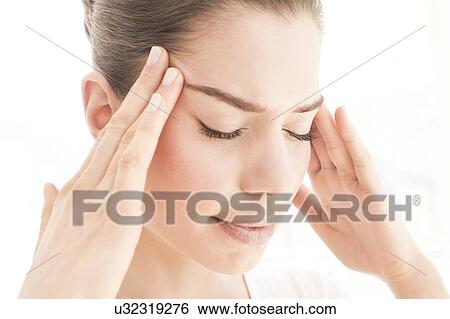 MODEL RELEASED. Young woman in pain rubbing her temples. View Large Photo Image Stock Photograph - MODEL RELEASED. Young woman in pain rubbing her temples.. Fotosearch