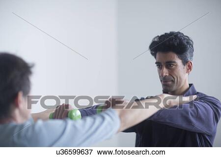 Stock Photo - Physiotherapist examining patient. Fotosearch