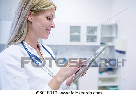 Portrait of female doctor using digital tablet. View Large Photo Image Stock Photo - Portrait of female doctor using digital tablet.. Fotosearch