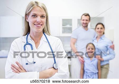 Portrait of female doctor with family in background. View Large Photo Image Stock Photo - Portrait of female doctor with family in background.. Fotosearch