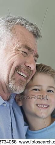 Stock Photo - Portrait of grandfather and grandson smiling.. Fotosearch