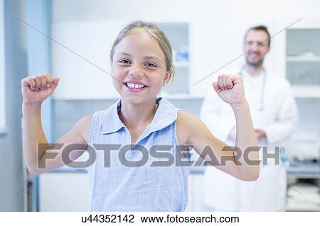 Portrait of young girl cheering in doctor's surgery. View Large Photo Image Stock Image - Portrait of young girl cheering in doctor's surgery.. Fotosearch