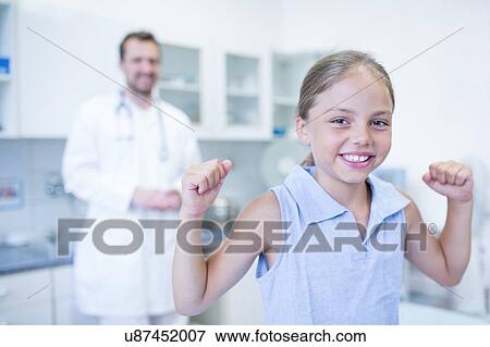 Portrait of young girl cheering in doctor's surgery. View Large Photo Image Stock Photo - Portrait of young girl cheering in doctor's surgery.. Fotosearch