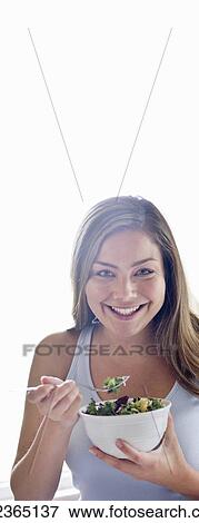 Portrait of young woman eating salad. View Large Photo Image Stock Photo - Portrait of young woman eating salad.. Fotosearch