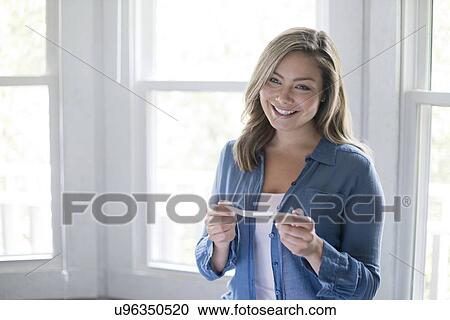 Portrait of young woman with pregnancy test, smiling. View Large Photo Image Stock Image - Portrait of young woman with pregnancy test, smiling.. Fotosearch