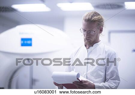 Stock Image - Radiologist checking notes. Fotosearch