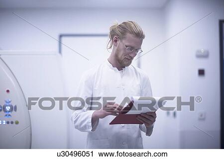 Stock Image - Radiologist checking notes. Fotosearch