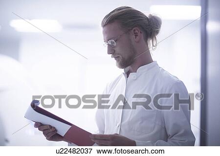 Radiologist checking notes View Large Photo Image Stock Photo - Radiologist checking notes. Fotosearch