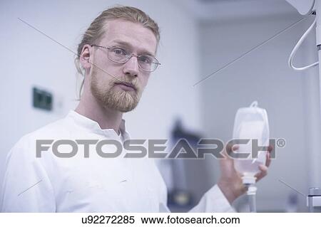 Stock Photography - Radiologist holding solution bottle. Fotosearch