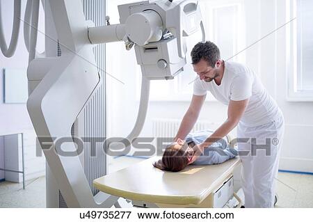 Radiologist positioning female patient for x-ray. View Large Photo Image Stock Photo - Radiologist positioning female patient for x-ray.. Fotosearch