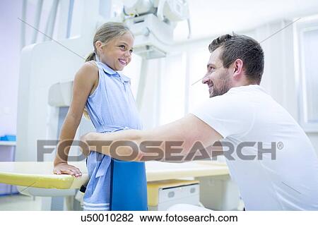Radiologist preparing young girl for x-ray in hospital. View Large Photo Image Stock Image - Radiologist preparing young girl for x-ray in hospital.. Fotosearch