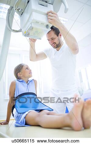 Stock Photography - Radiologist preparing young girl for x-ray in hospital.. Fotosearch