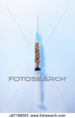 Stock Image - Soy beans in syringe, studio shot.. Fotosearch