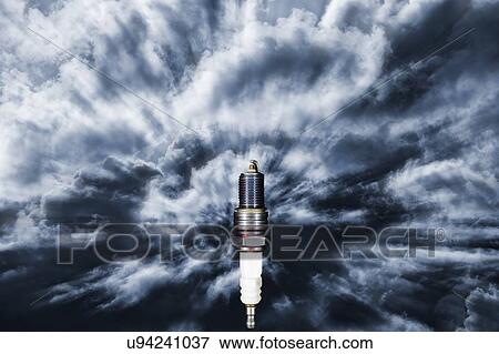 Stock Photo - Spark plug fetching energy and power from a dark and stormy sky.. Fotosearch