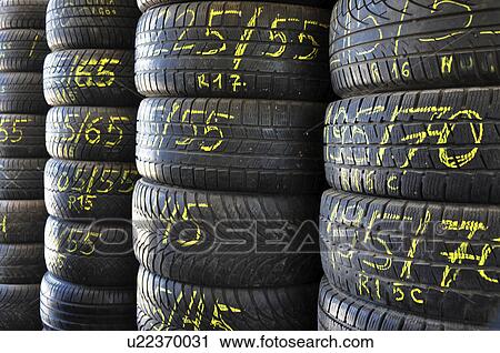 Stock Image - Stack of tyres in a shop. Fotosearch