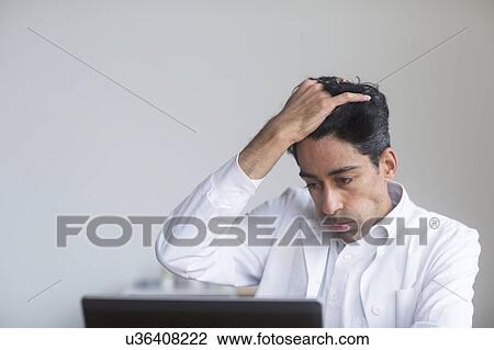 Stock Image - Stressed doctor. Fotosearch