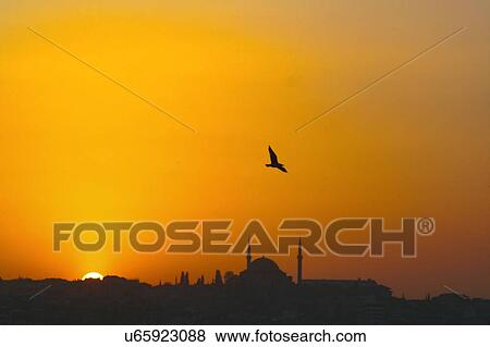 Sunset over Istanbul, Turkey, as seen from the Bosphorus. A mosque can be seen at centre. View Large Photo Image Stock Photo - Sunset over Istanbul, Turkey, as seen from the Bosphorus. A mosque can be seen at centre.. Fotosearch