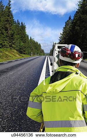 Stock Photograph - Surveying a country road. Fotosearch