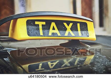 Picture - Taxi sign on car rooftop. Fotosearch