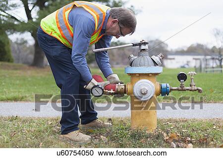 Technician installing hydrant attachment with sensor for flushing mains. View Large Photo Image Stock Image - Technician installing hydrant attachment with sensor for flushing mains.. Fotosearch