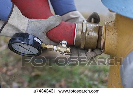 Technician installing hydrant attachment with sensor for flushing mains. View Large Photo Image Stock Image - Technician installing hydrant attachment with sensor for flushing mains.. Fotosearch