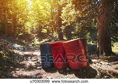 Stock Photo - Toxic waste barrels in forest. Fotosearch