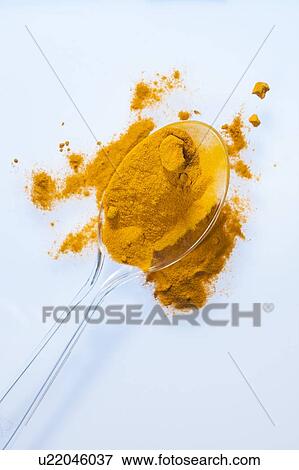 Stock Photo - Turmeric powder on spoon, studio shot.. Fotosearch