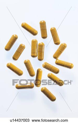 Stock Image - Turmeric supplement capsules, studio shot.. Fotosearch