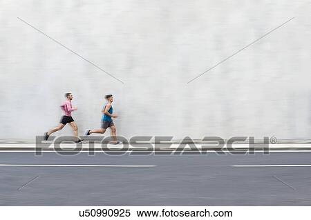 Two men running on pavement next to concrete wall. View Large Photo Image Stock Photography - Two men running on pavement next to concrete wall.. Fotosearch