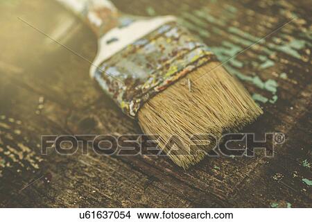 Picture - Used paintbrush on rustic wooden board. Fotosearch