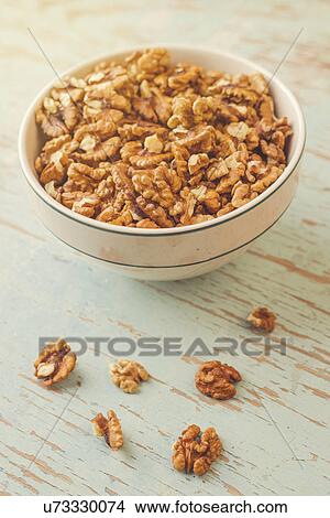 Picture - Walnut kernels in ceramic bowl. Fotosearch